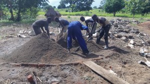 Mixing cement, sand, and small stones together