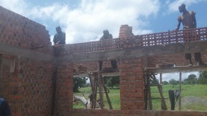 We are finishing up the brick work and making ready for the roof. Our bricks were made on our land with our soil with local labor. Because of the heat in the area the ceiling will be about 11 feet high and each room has large windows with vent bricks. 