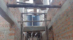 This 5000 liter tank will gravity feed our rooms. Our hope is that the water will be warmed in the attic for our baths.