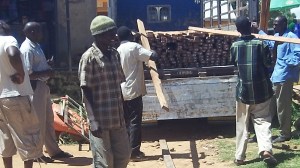 Loading lumber in Moyo town for the roof.