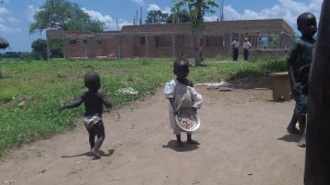 Our work on the Guesthouse is a family affair. Along with the builders we hire ladies who cook and haul water so we normally have a number of children at the work site. Soon a Water Harvest International representative will be here to help in picking out the spot for our new bore hole :-). 