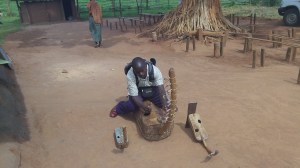 Sam trying to play one of the churches music instruments.