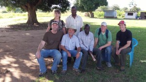 At the Ugandan/South Sudan border with the "Tennessee Trio". Seated: David, Jacob,Officer in Charge of Afoji Border Crossing, Michael, Eric.Standing: Carol, Immigration Officer