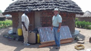 Outside Godfrey's rented tukalu. It is not far from the tree the church meets under.