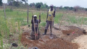Deep holes were dug for the posts of the sign. The guys had never seen a post hole digger and they quickly fell in love with mine.