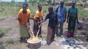 Sam with some of cooks. They are mingling cassava flour which is the main food Obongi