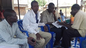 Godfrey is on the far left, the man in the white is the the converted Muslim and one next to him is the friend he brought Sunday. A brother is sharing God's Word. He trusted in Christ alone for his salvation and joined us for the rest of the day for the teaching.
