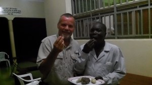 Godfrey and I enjoying a late night snack of sweet potatoes and white ants (termites). The white ants are delicious!